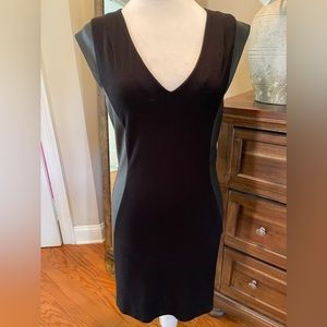 Jersey knit dress with leather panels on sides and cap sleeves, zip up back.